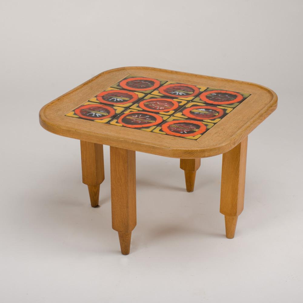 A decorative tile top table by Guillerme et Chambron, the oak table featuring nine original ceramic orange, yellow and green tiles, circa 1970.