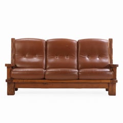 A French Heavy Oak Brutalist style Open Arm Sofa, C. 1960.