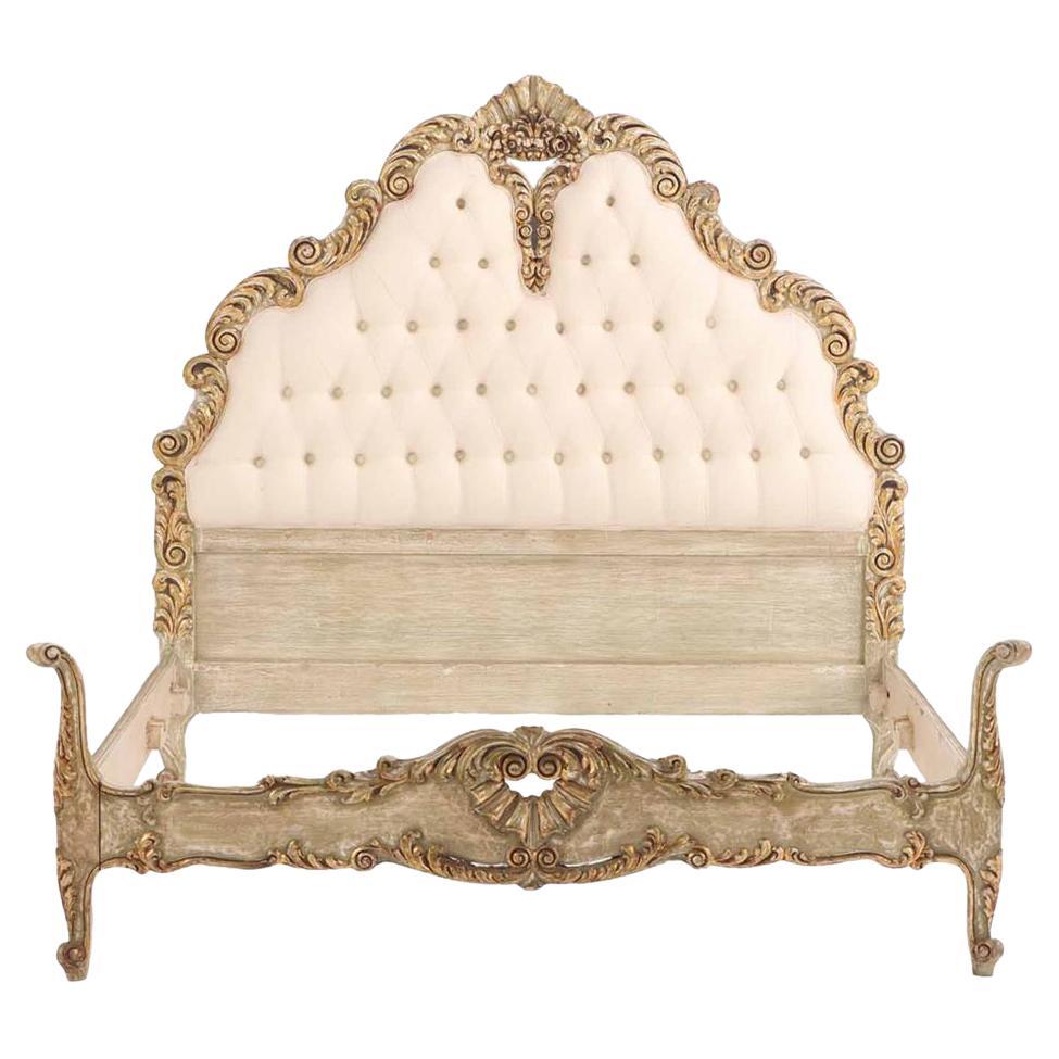 A French Hollywood Regency style painted and gilt carved full size bed, C. 1940. For Sale