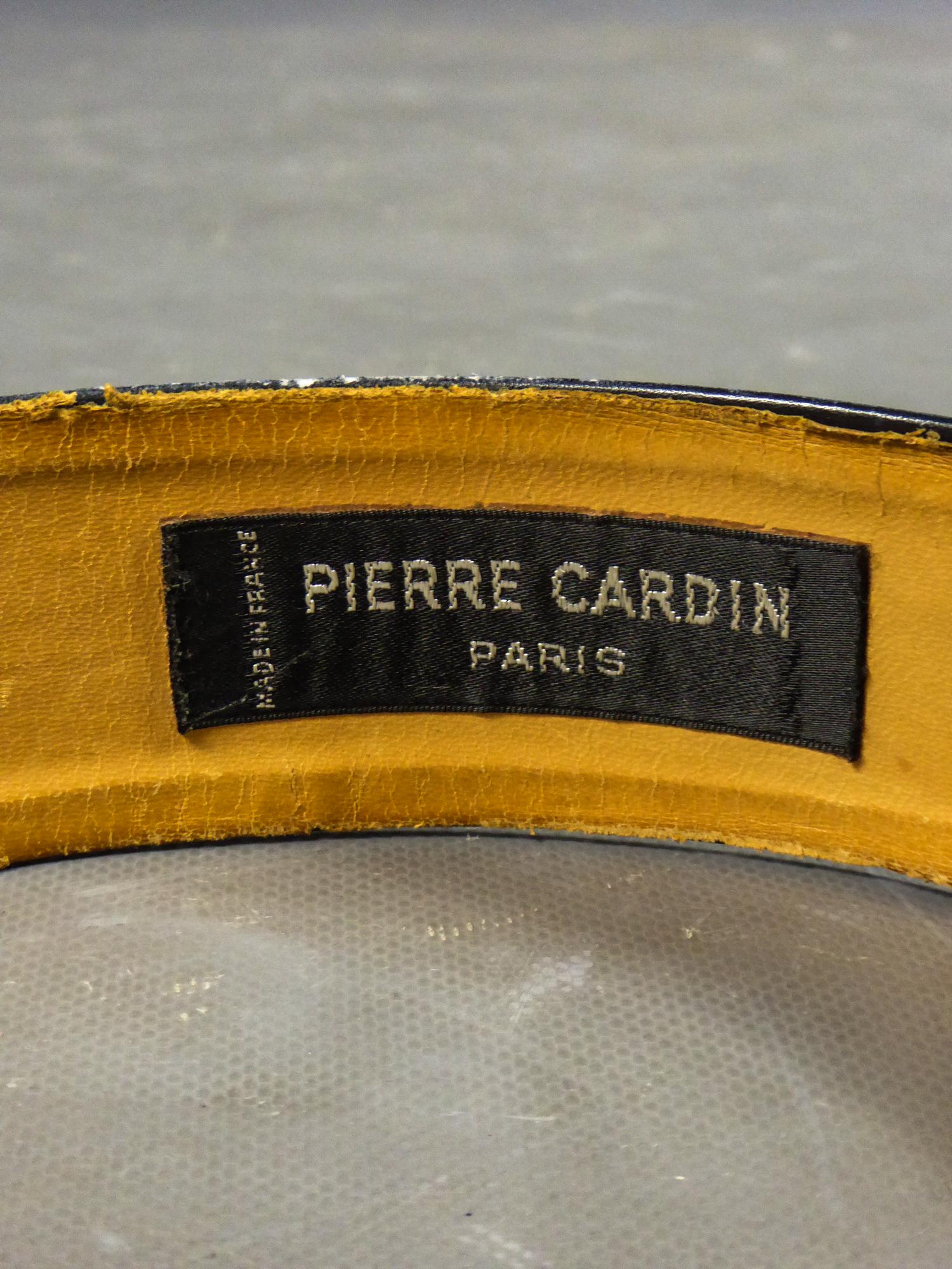 Circa 1970/1980
France

Belt in black leather by Pierre Cardin from the 1970s or 1980s. Belt with minimalist design slightly curved to the shape. Buckle in silver chrome-plated steel representing the famous Pierre Cardin logo. Wrong side lined with