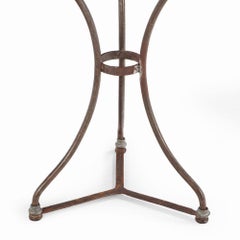 A French iron and brass marble top bistro table, C. 1900.