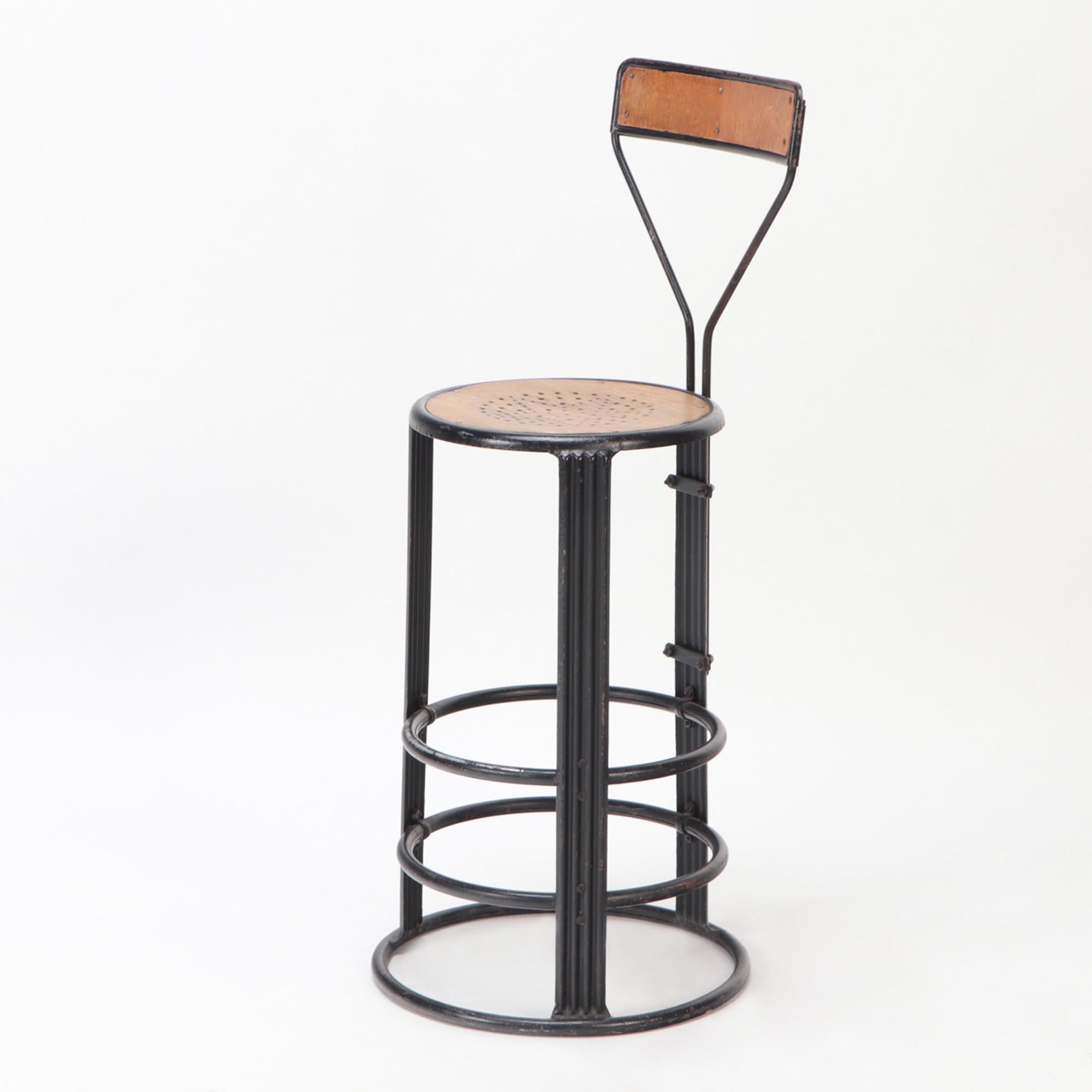 A French Iron counter stool with wooden seat and backrest, C 1910.