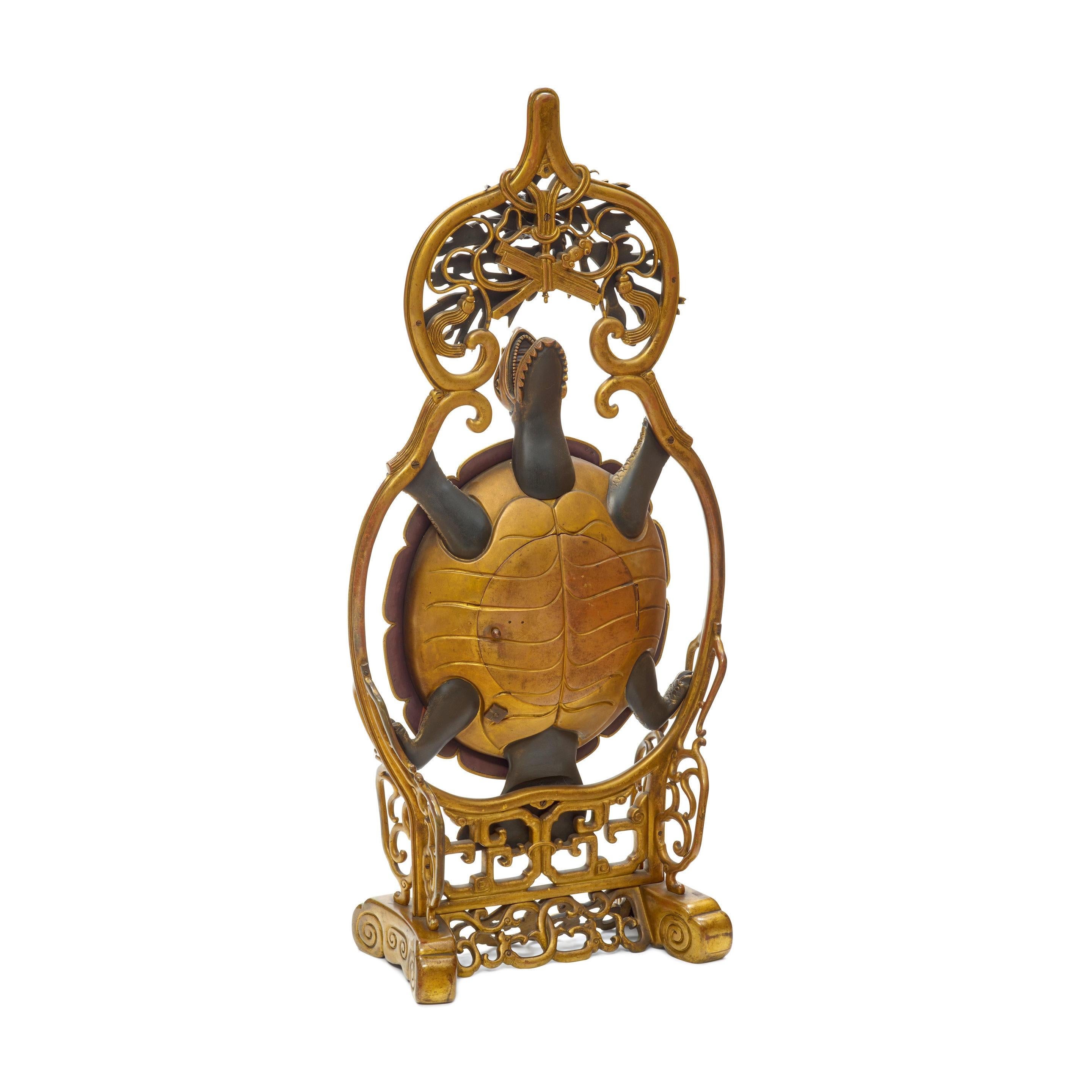 A FRENCH JAPONAISE CLOISONNÉ GILT AND PATINATED METAL TURTLE-FORM CLOCK
Almost certainly designed by Émile-Auguste Reiber for L'Escalier de Cristal, Paris, circa 1870-80
Impressed to works 23642.
height 33in (84cm); width 15in (38cm); depth 7 1/4in