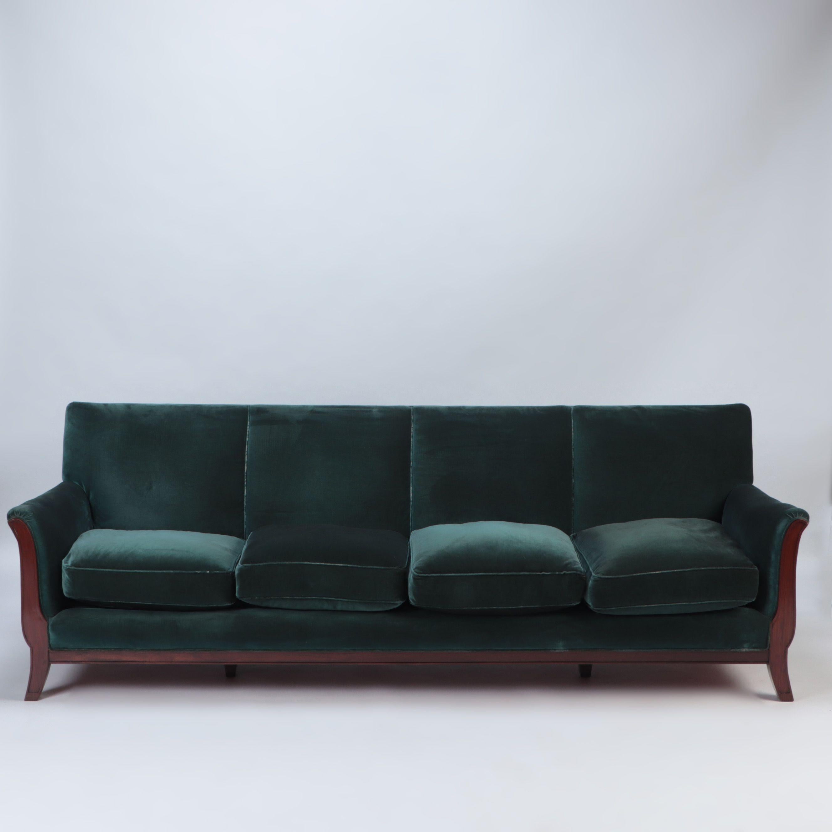 A French large sofa with green velvet upholstery on angled square tapering legs, circa 1945.