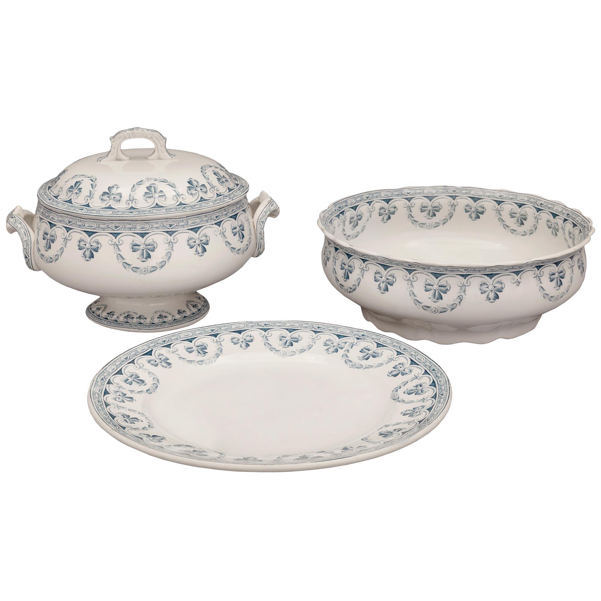 A very elegant Country French late 19th century Louis XVI st. white Saint Amand et Hamage porcelain dining set. This fifty nine piece set is signed 'Saint Amand et Hamage', and has a traditional royal blue design throughout. Each porcelain serving