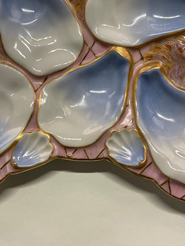 A good French Porcelain Oyster plate with blue and pale pink colors for the company Wilhelm & Graef in NY. Stamped on back. No damage reported. The plate is 8.5