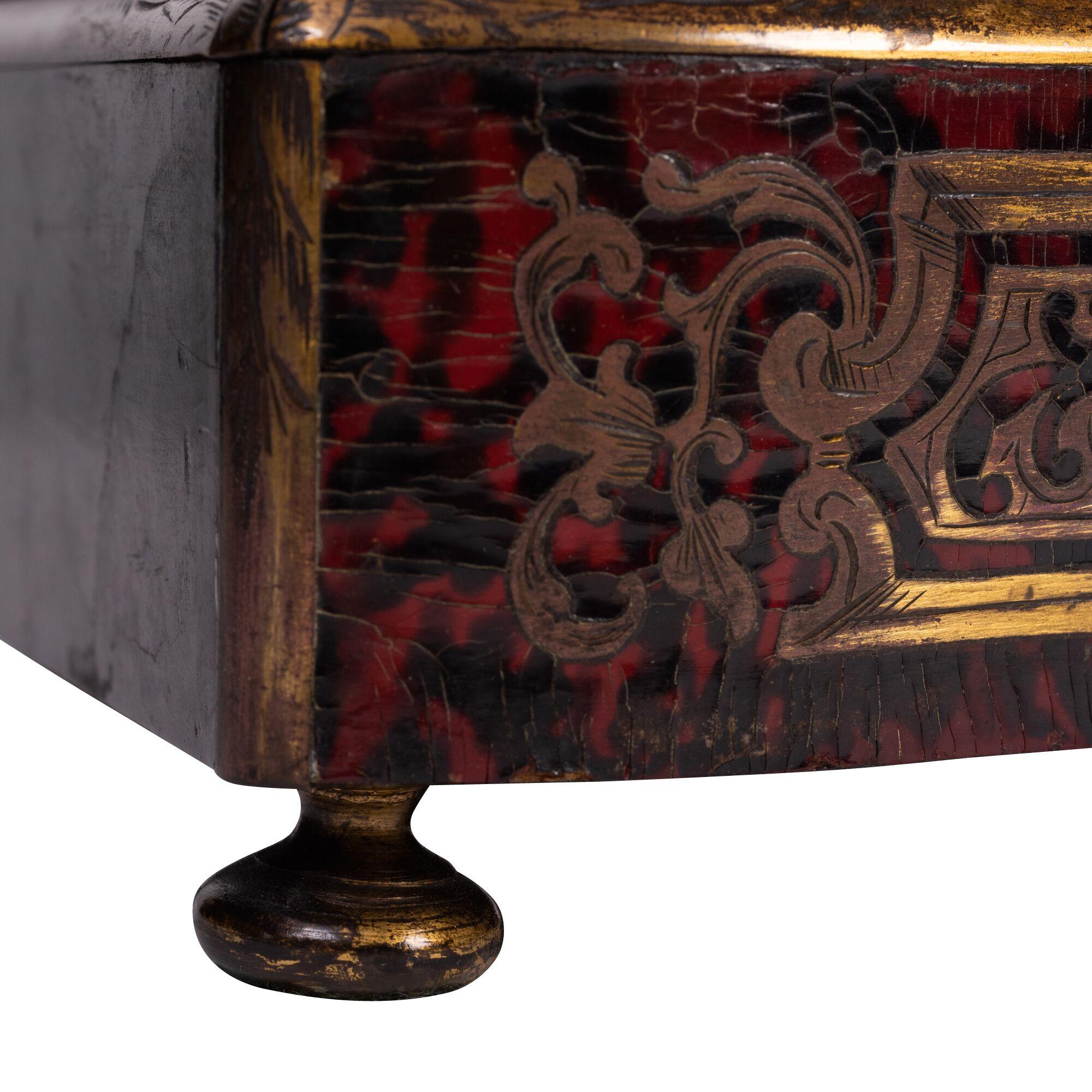 A French Louis XIV style tortoiseshell, brass and pewter-inlaid Boulle marquetry liquor casket, circa 1850, hinged canted rectangular top with outswept sides opening to four decanters and various cups, raised on short foliate-cast round