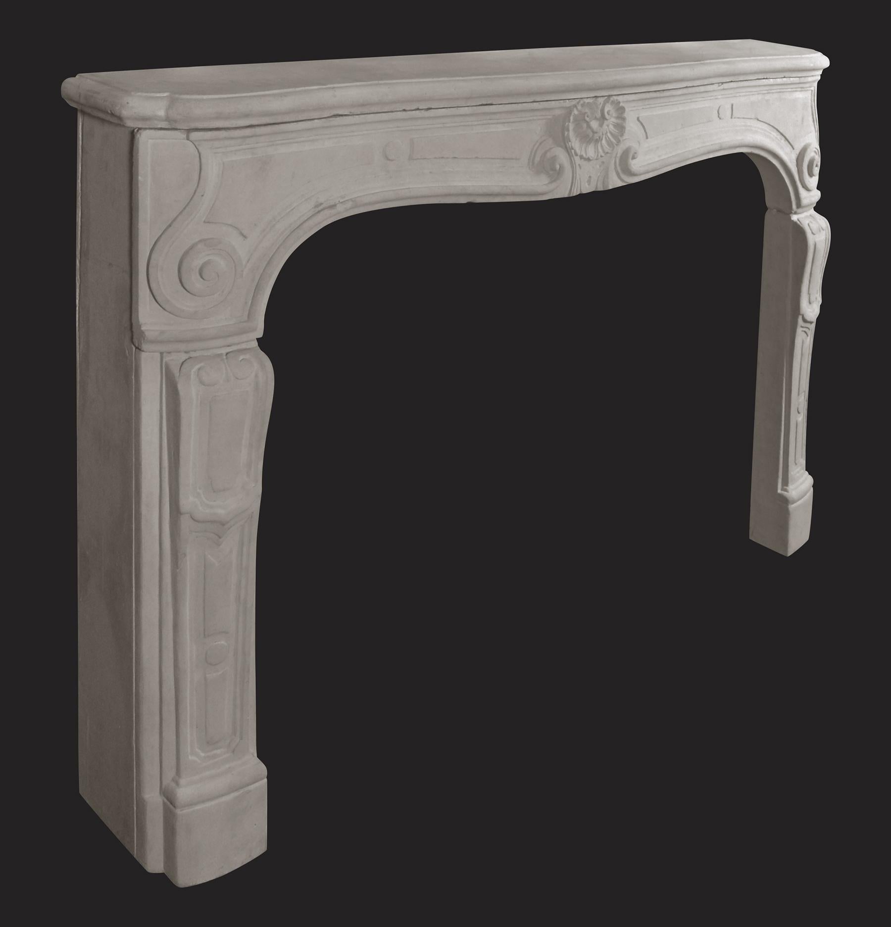 A French Louis XV antique stone fireplace with panelled console jambs supporting the carved scrolled entablature with central shell over scrolls. Restored.

Internal Width: 52.25