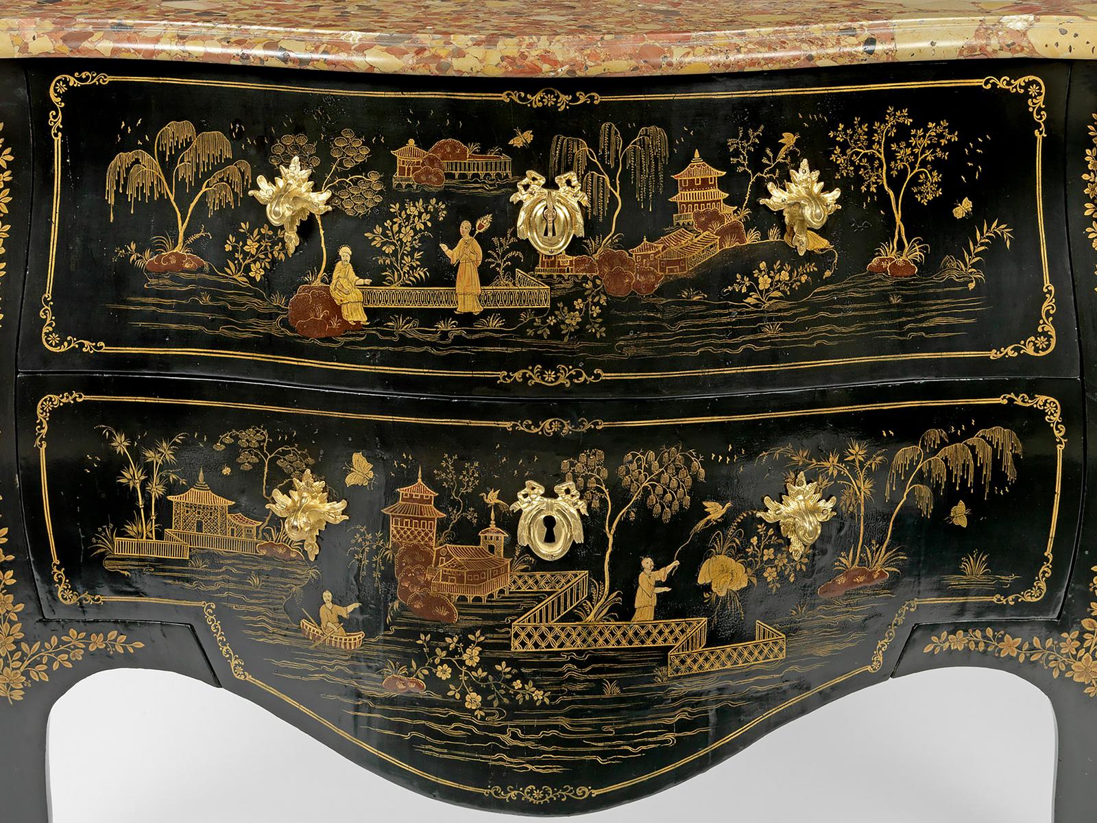 The serpentine-fronted, bombé commode decorated with French japanning has a moulded brêche violet marble top, above two deep drawers, the lower one with a shaped apron. The sides have similar decorated panels and the shoulders are headed with ormolu