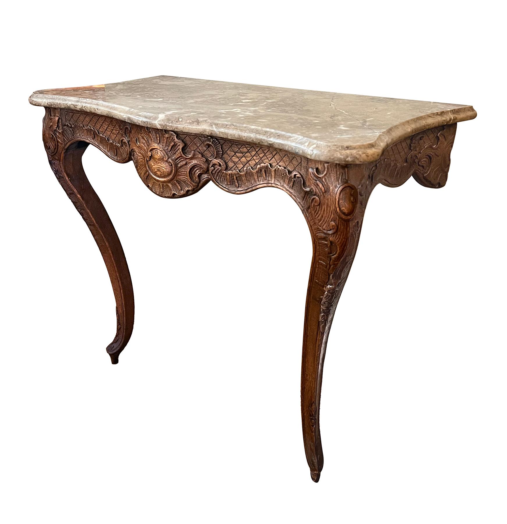 with serpentine rasotica marble top above a conforming carved oak base with dramatic scalloped apron centering a bold shell medallion flanked by rocaille carving; raised on cabriole supports with similar rocaille carving