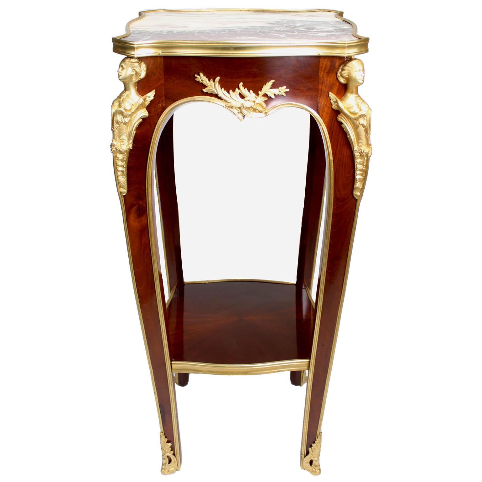 A fine French Louis XV Style Mahogany and Gilt-Bronze (Ormolu) Mounted Side Table, Attributed to Franc¸ois Linke (1855-1946). The square shaped table fitted with a Bre^che Violette marble top with a gilt bronze trim, the body surmounted on each