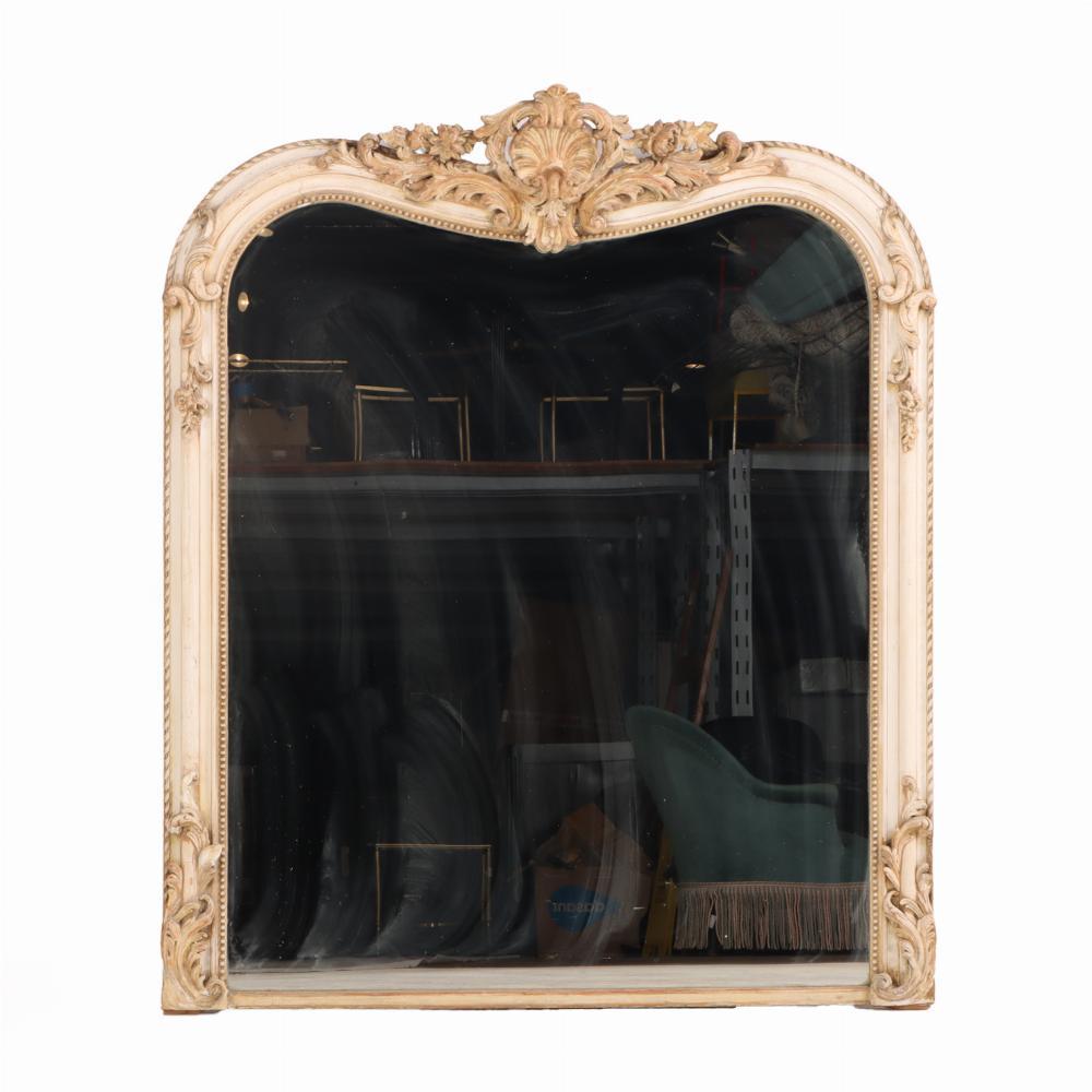 An exquisite Louis XV style mirror, featuring an elegant ivory-painted gesso frame richly adorned with gilt embellishments. The shaped and scrolled surround is intricately detailed, embodying the graceful asymmetry and fluid curves characteristic of