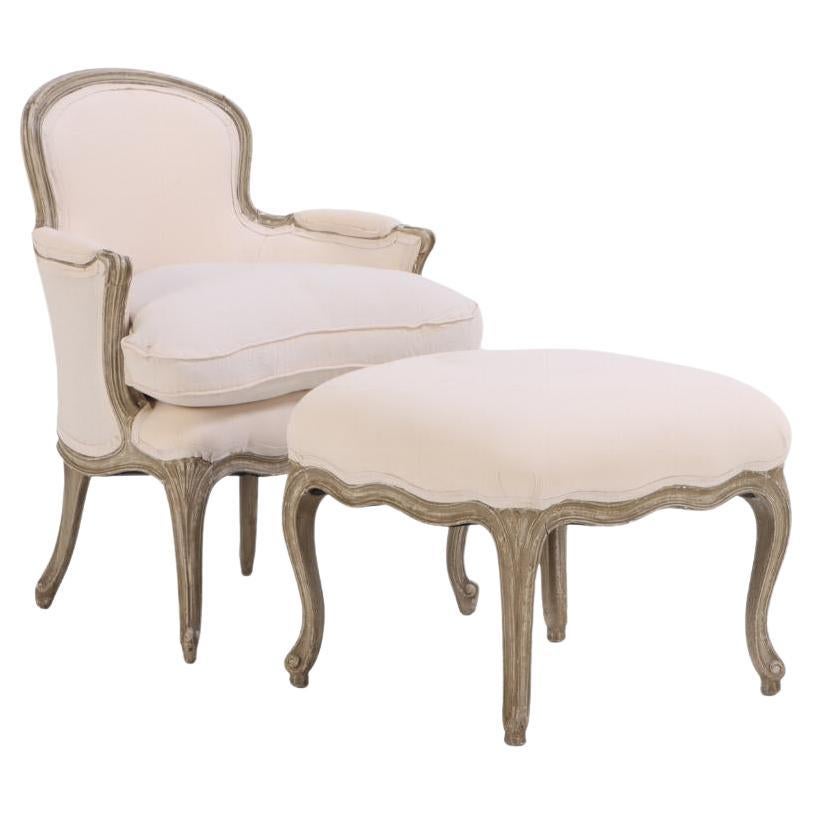 A French Louis XV style painted armchair and matching stool, C. 1910.