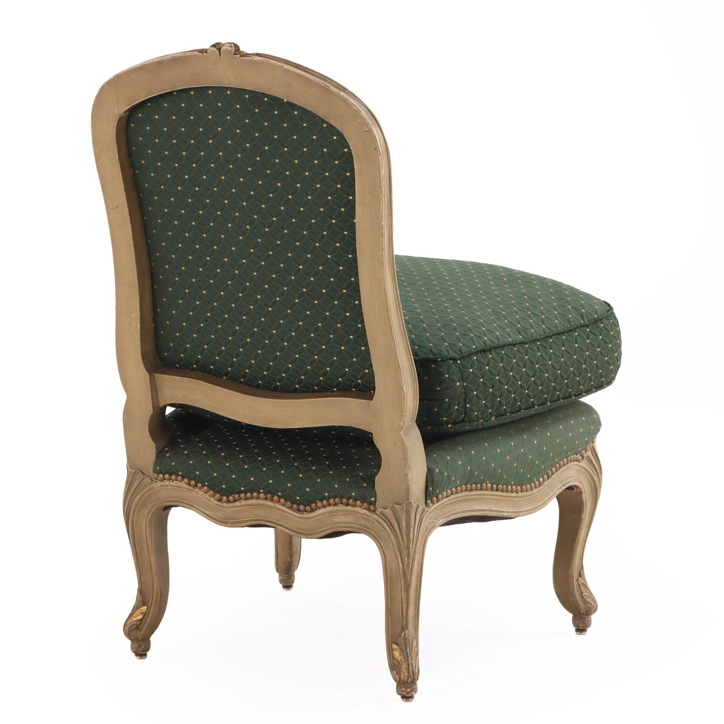 Charming and elegant, this petite chair features a carved and painted frame in the Louis XV style with a shapely back and cabriole legs. The overstuffed seat cushion is upholstered in a deep green fabric, matching upholstered back and seat frame,
