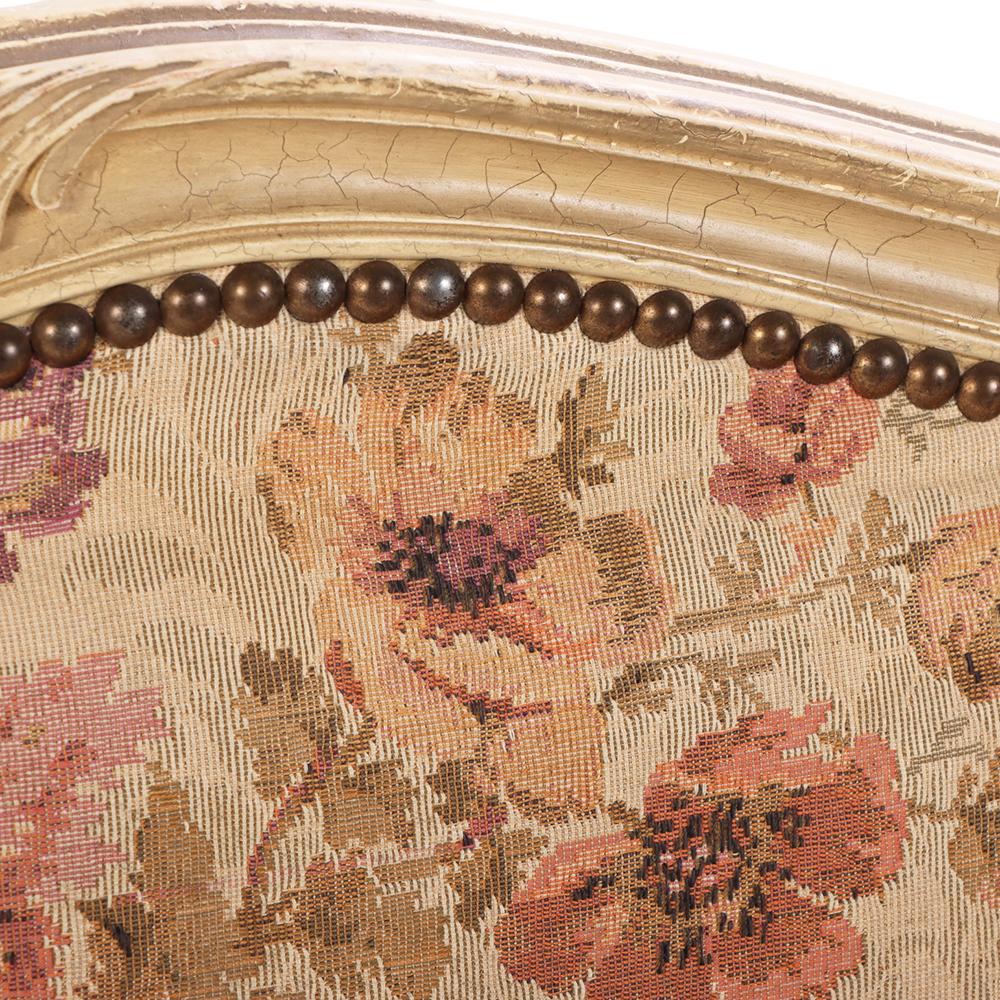 The full size frame having typically shaped headboard with carved crest, a curved footboard with carved crest and apron, both upholstered in 