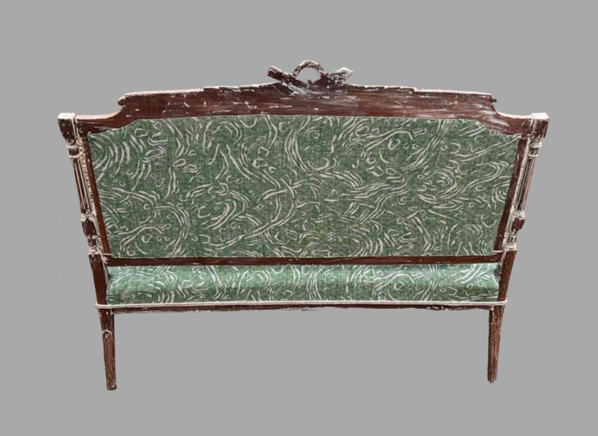 An attractive Louis XV1 style beech canape circa 1900, the frame partially painted in a light grey with a gadrooned back rail and on turned fluted legs are covered in a Fermoie green patterned fabric. Seat Height 40 cm and Arm Height 51 cm.