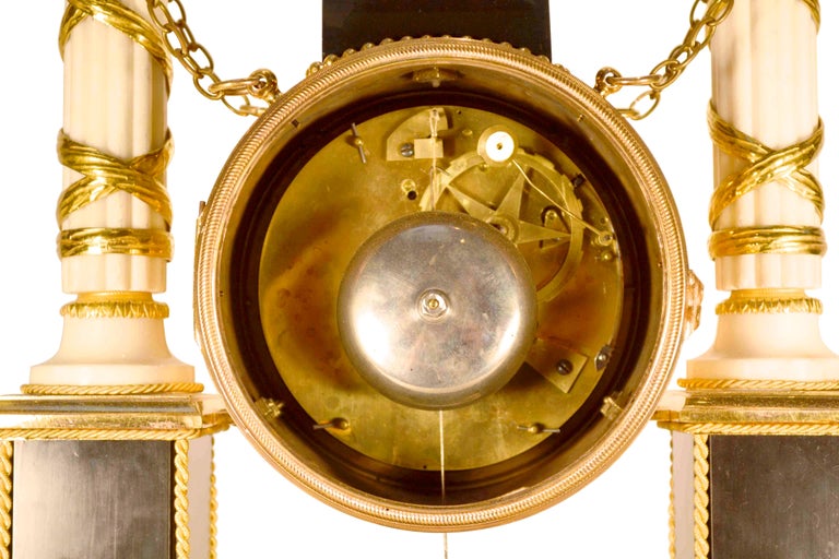 A period Louis XVI Ormolu black and white marble mantel clock made in the last quarter of the 18th century. The white enamel dial with black Arabic numerals is contained within a drum-shaped case surmounted by a biscuit classical figure of Euterpe.