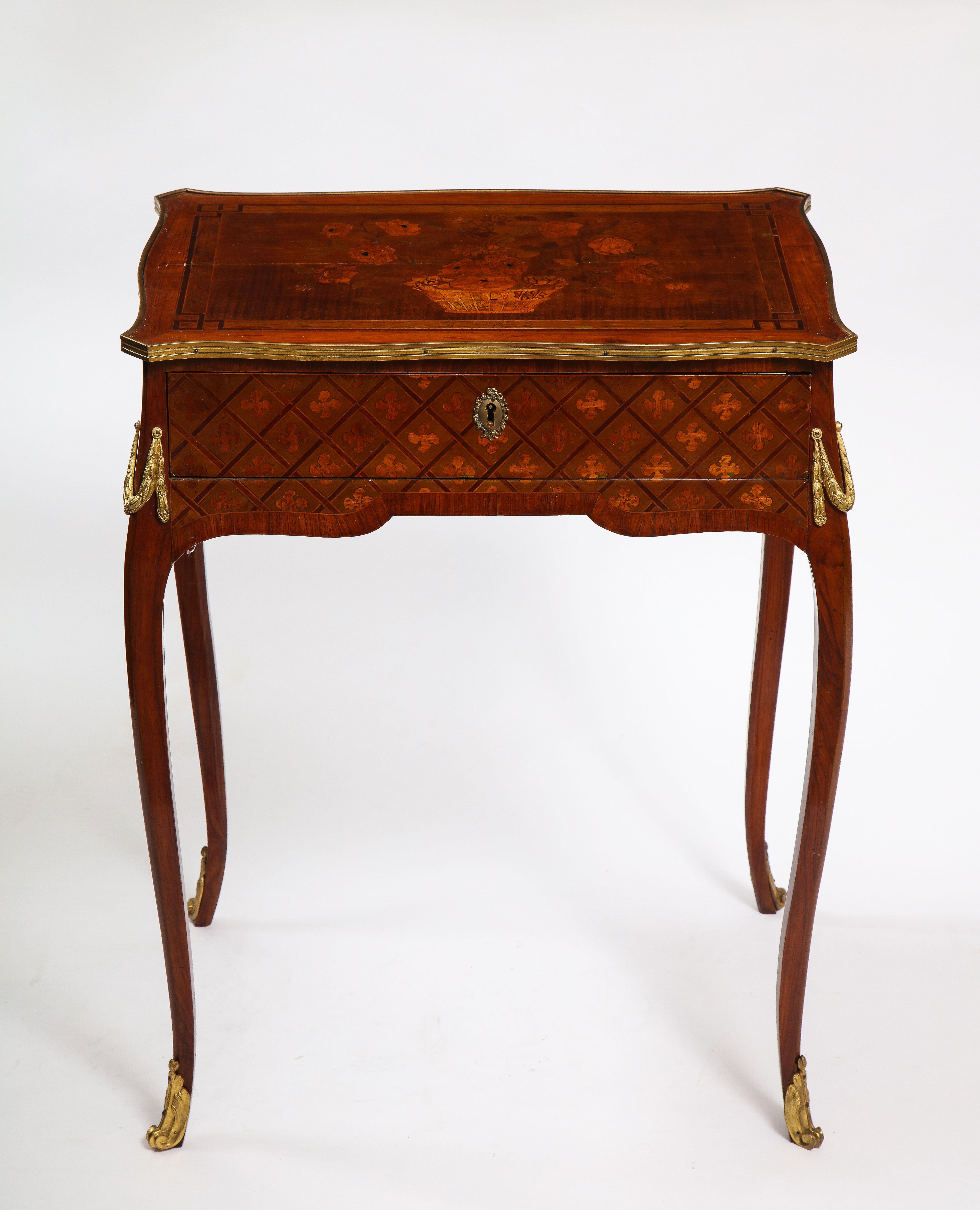 A gorgeous French Louis XVI period dore bronze mounted marquetry and parquetry side table. Each piece of this side table is beautifully hand-cut and fitted with a beautiful geometric parquetry design of prismatic pieces of light and dark hard-wood.