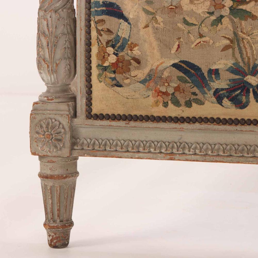 The head and foot boards are slightly arched and flanked by detached columns carved with twisted grooves and gadroons. The wood has a wonderful tone and patina. The upholstery is worn as one would expect for beds of this age and amplifies the