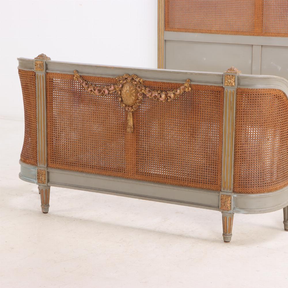 20th Century A French Louis XVI style carved, painted and giltwood full size bed, C 1900.