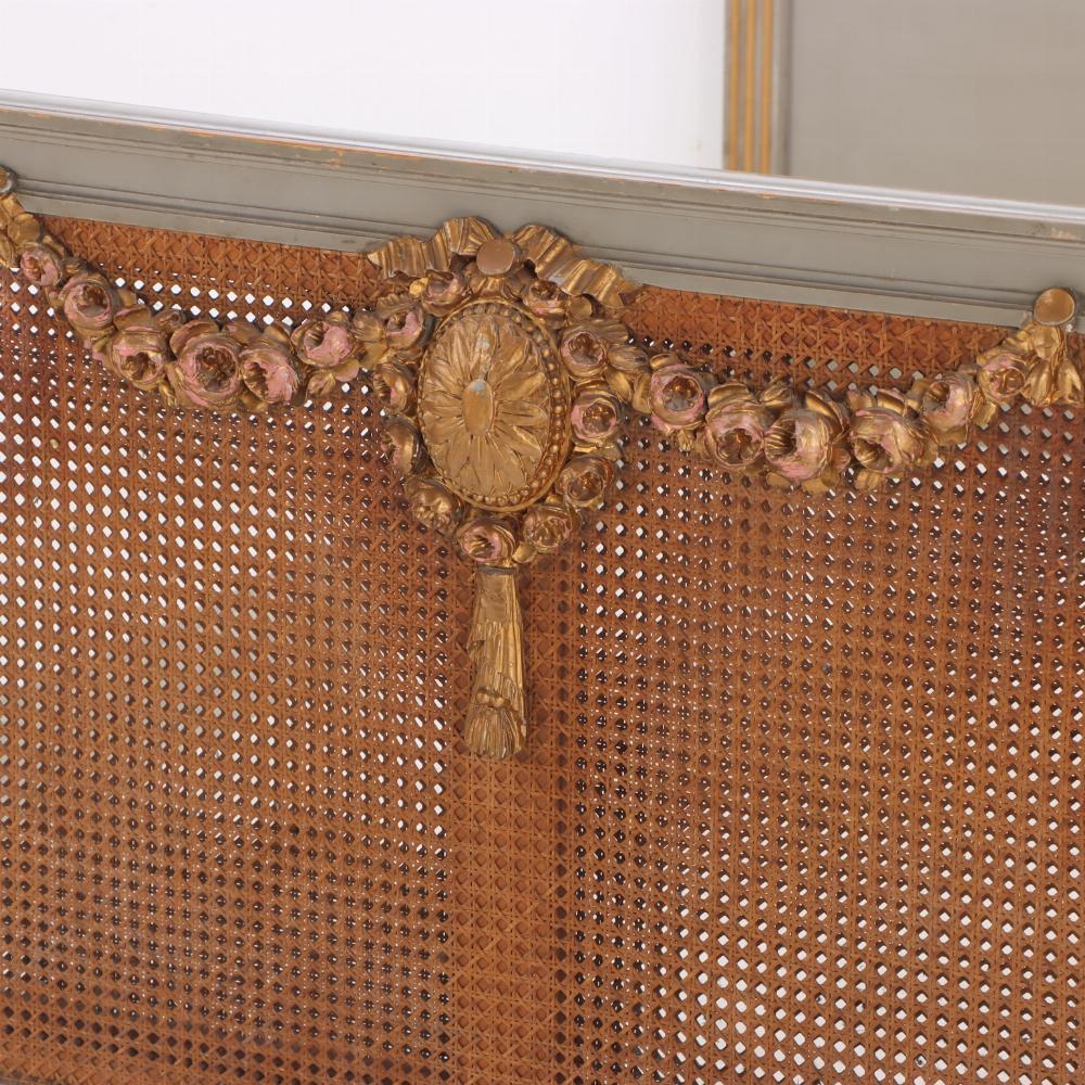 Cane A French Louis XVI style carved, painted and giltwood full size bed, C 1900.