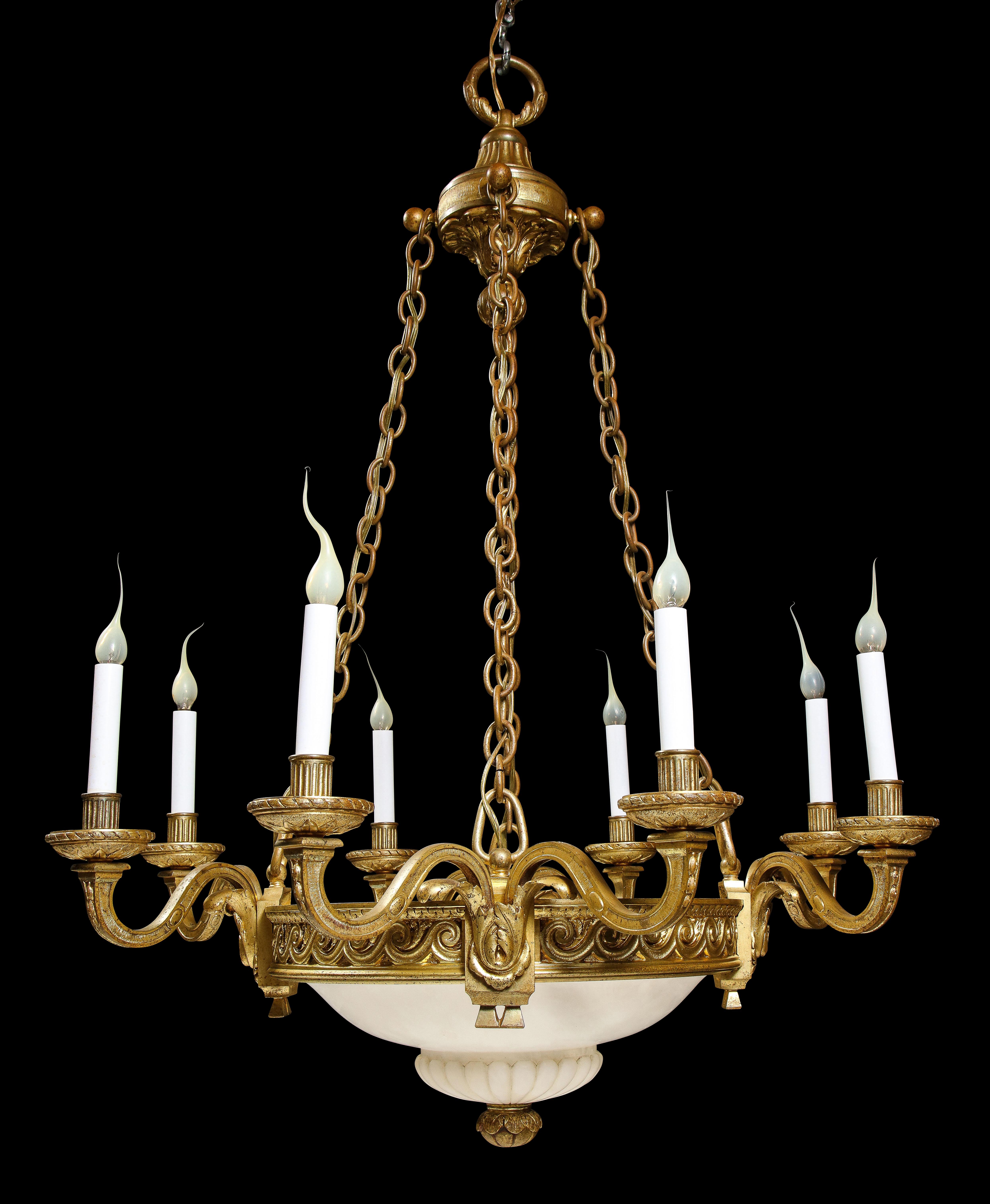 A Fine Antique French Louis XVI Style Gilt bronze and Hand carved alabaster multi light circular form chandelier of great quality. This unique chandelier is embellished with a very ornate hand carved circular alabaster dish decorated with a gilt