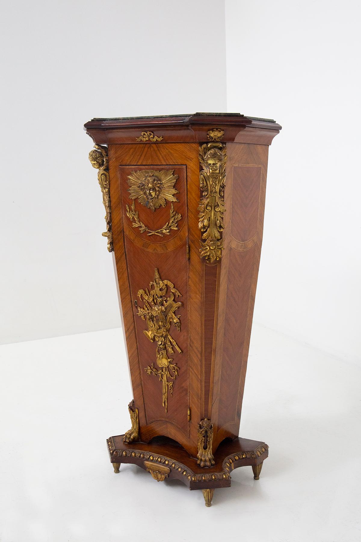 Transport yourself to a bygone era of opulence and grandeur with this elegant French pedestal in the style of Louis XVI. While its design harkens back to the 18th century, this exquisite piece of artistry likely hails from the late 19th to early