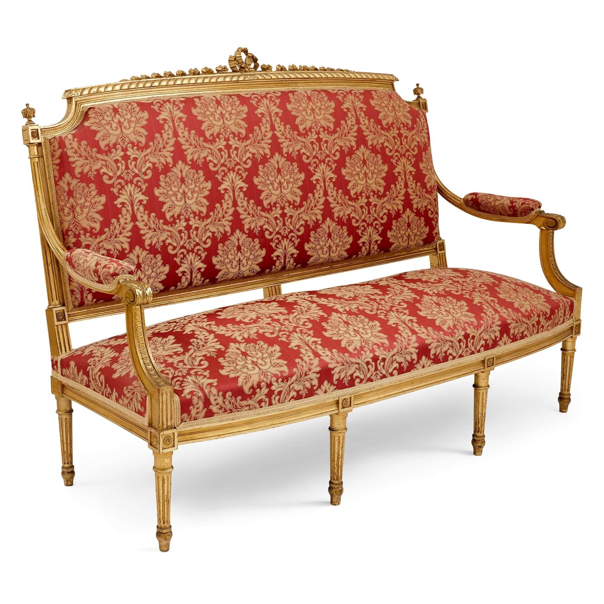 A Louis XVI Style Giltwood Salon Suite
French, 19th Century
Canape:  height 113cm, width 164cm, depth 65cm
Armchair: height 104cm, width 65cm, depth 57cm
Chair: height 99cm, width 54cm, depth 52cm

This superb five-piece salon suite consists of a