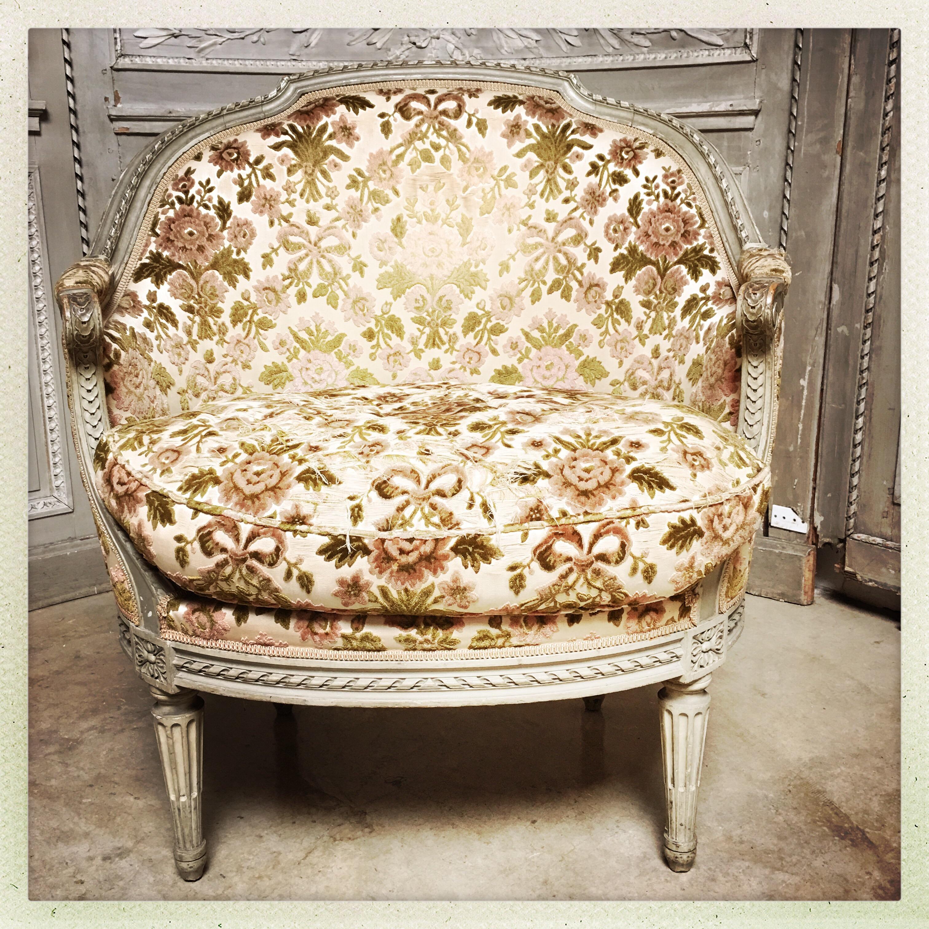 A French Louis XVI style marquise (extra wide chair to accommodate ladies dresses) in a French gray painted finish.