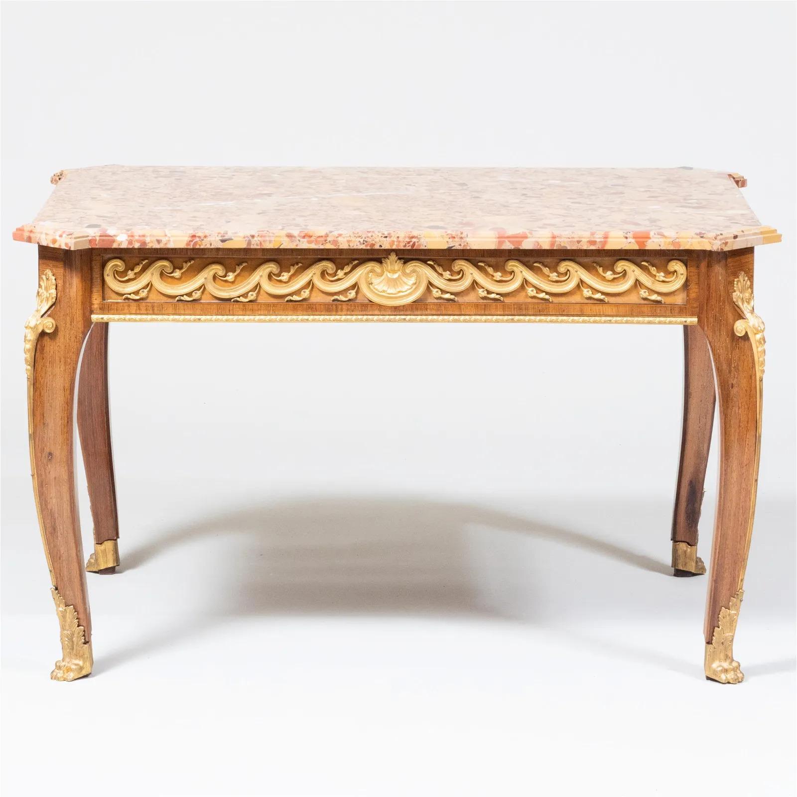 A French Louis XVI Style Ormolu-Mounted Mahogany Coffee Table, C. 1880
fitted with a Breche d 'Alep marble top and two end drawers.

A remarkable piece that showcases the elegance and craftsmanship characteristic of the Louis XVI era. Crafted in the