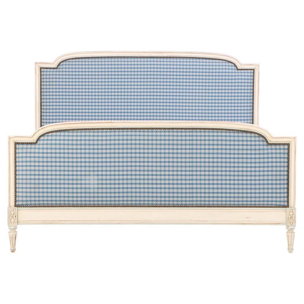 A French Louis XVI style painted and carved queen bed, C. 1920. For Sale