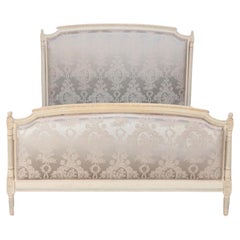 A French Louis XVI style painted and upholstered full size bed C 1940.