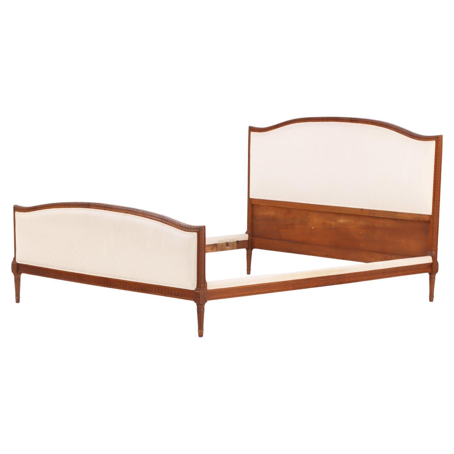 A French Louis XVI style Walnut Full Size Bed, C. 1930.