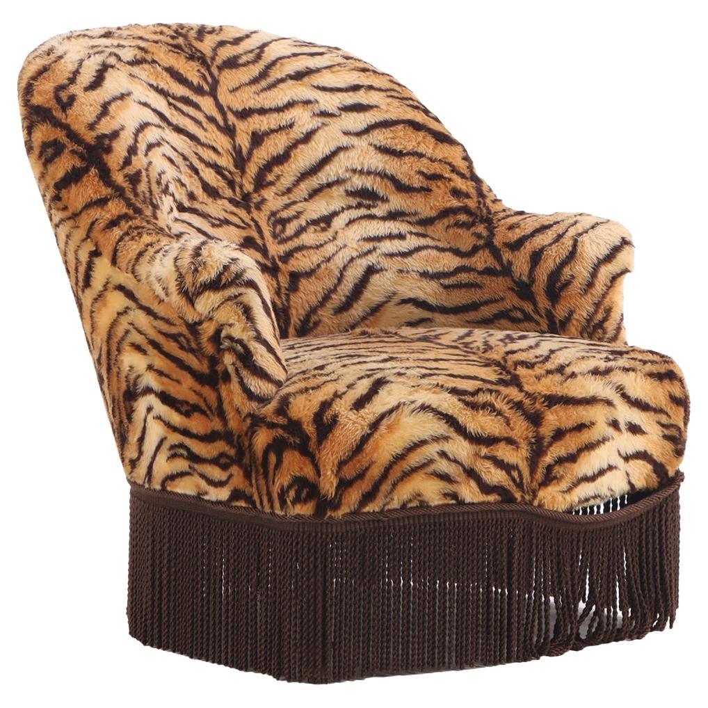 A French Lounge Chair covered in faux tiger fabric, 19th C.. For Sale
