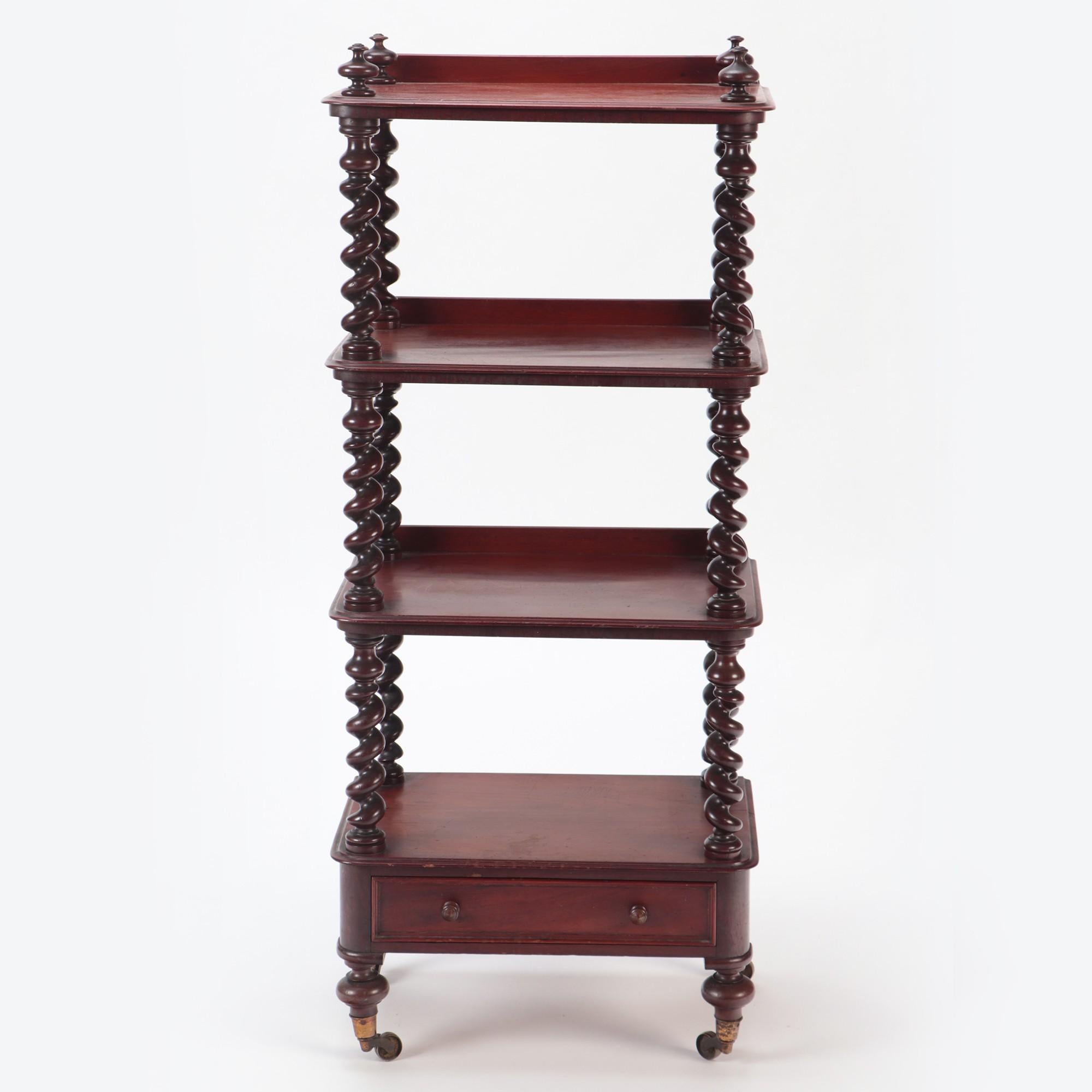 A French four shelves mahogany Etagère, 19th C. The shelves are separated by hand turned barley twist shelf supports. Last shelve has a drawer below. The Etagere rests on turned feet ending with the original brass casters.