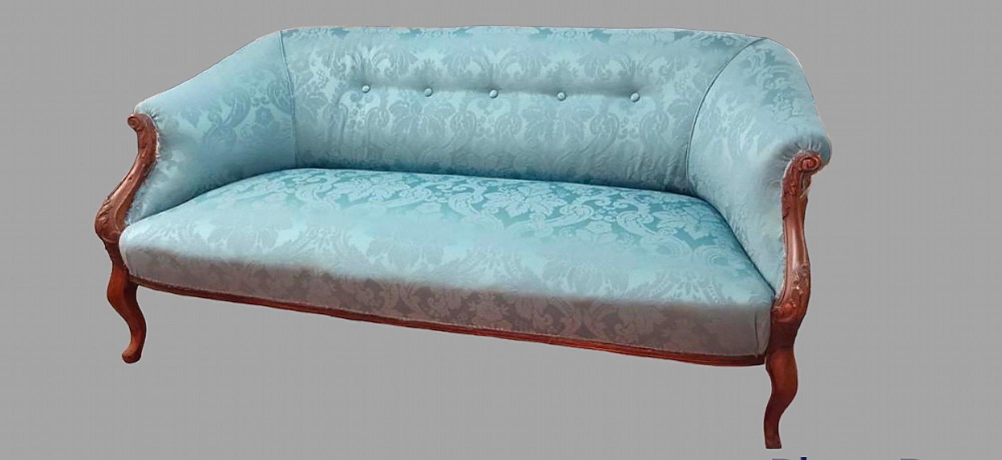 A French Mahogany sofa circa 1900 that has been reupholstered in a blue silk damask with scroll arms on cabriole front legs. Measure: seat height 36 cm.
