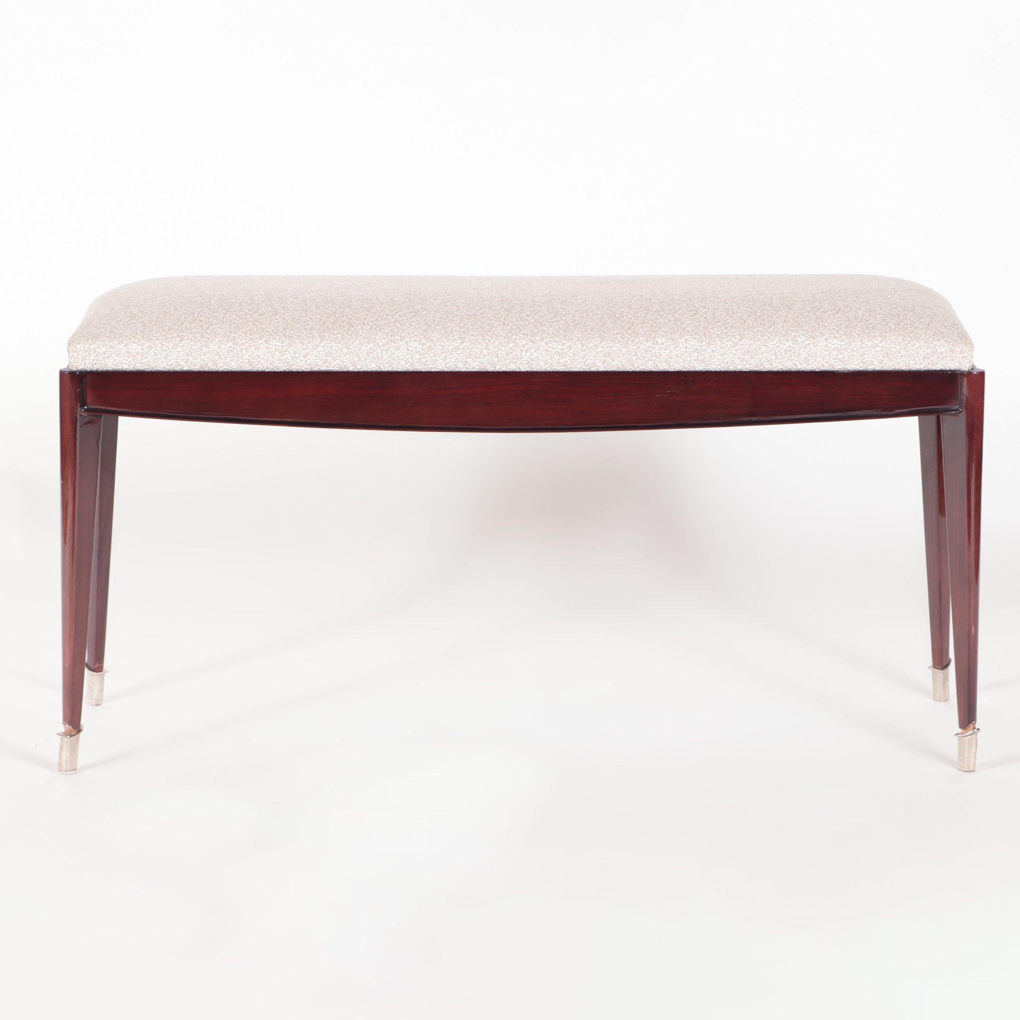 A very elegant French mahogany upholstered bench with silvered mounts and resting on four tapering legs, circa 1930.