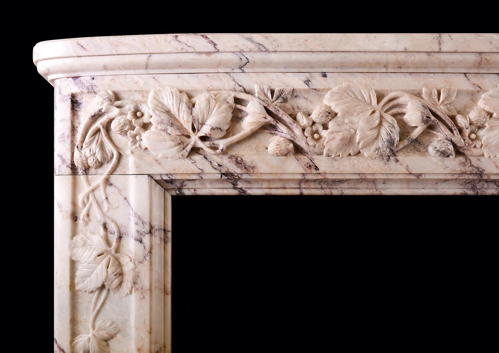 A fine quality French marble fireplace in Breche Rose de Lez marble. The bowed frieze and jambs carved with flowers, fruit and leaf work throughout. Bowed shelf above. The outgrounds with original antiqued brass vents. Late 18th/early 19th century.