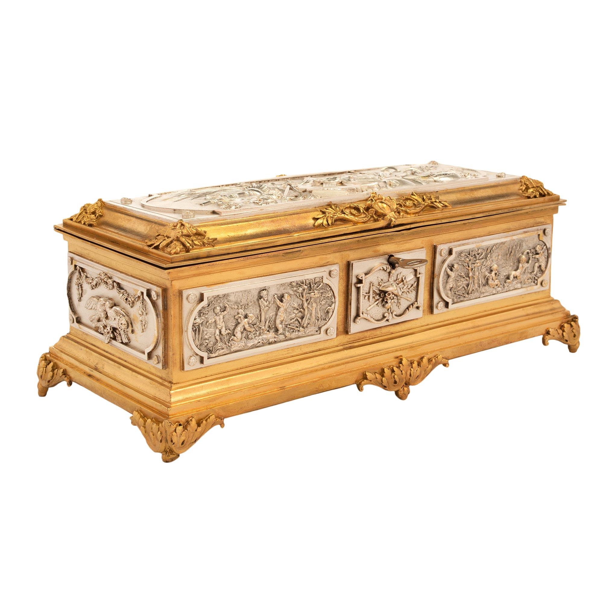 A wonderful and high quality French mid-19th century Louis XVI style jewelry box in ormolu and silvered bronze. The rectangular shaped box is raised by scrolled acanthus leaf designed supports. The front has three raised and richly chased panels,