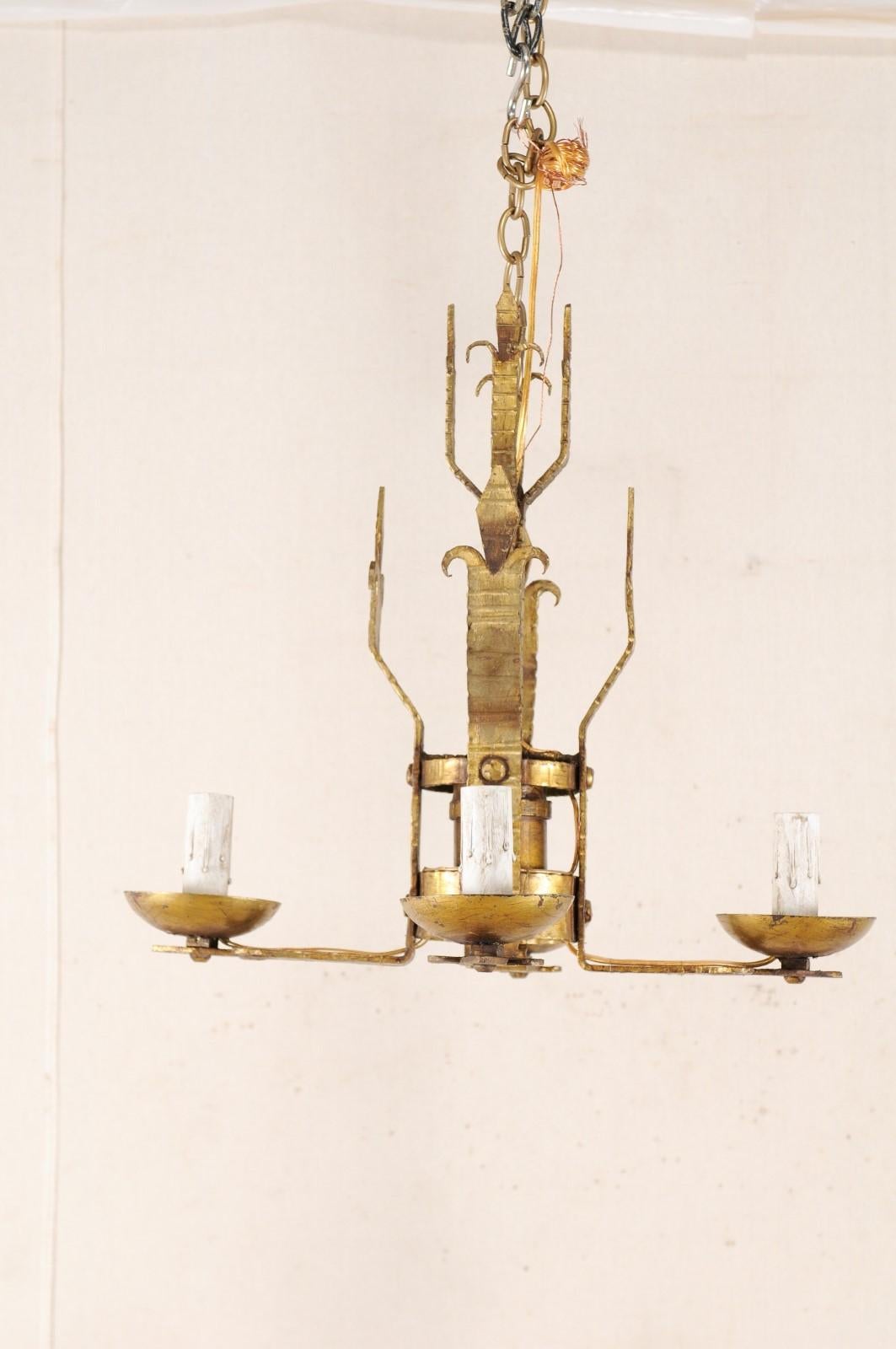 French Mid-20th Century Four-Light Gold Iron Chandelier in Fleur de Lys Motif In Good Condition For Sale In Atlanta, GA