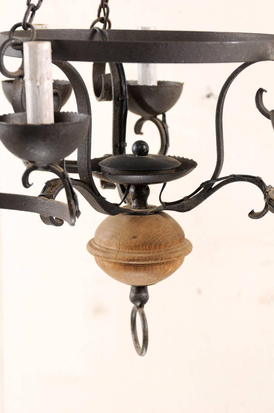 Metal French Midcentury Forged Iron Chandelier with a Carved Wood Sphere Accent