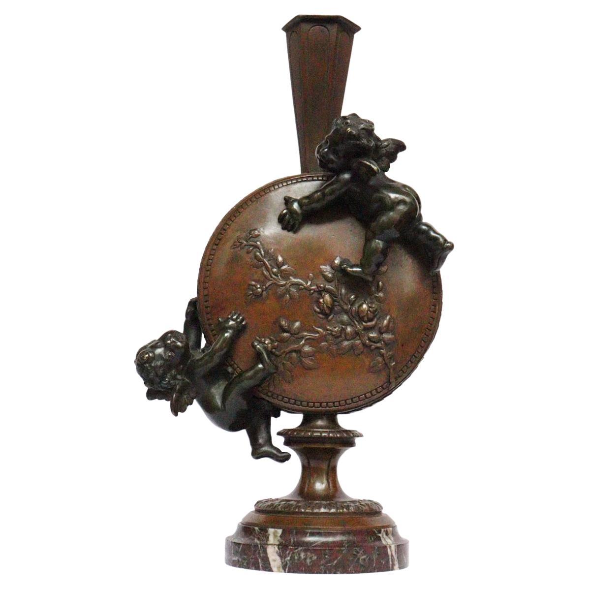 A French patinated bronze flask-shaped vase by Auguste Moreau (1834-1917)
Cast in high relief with cloud putti, both faces with bunch of flowers, Inscribed Auguste Moreau
On a spreading circular marble foot
Cast from a model by Auguste Moreau