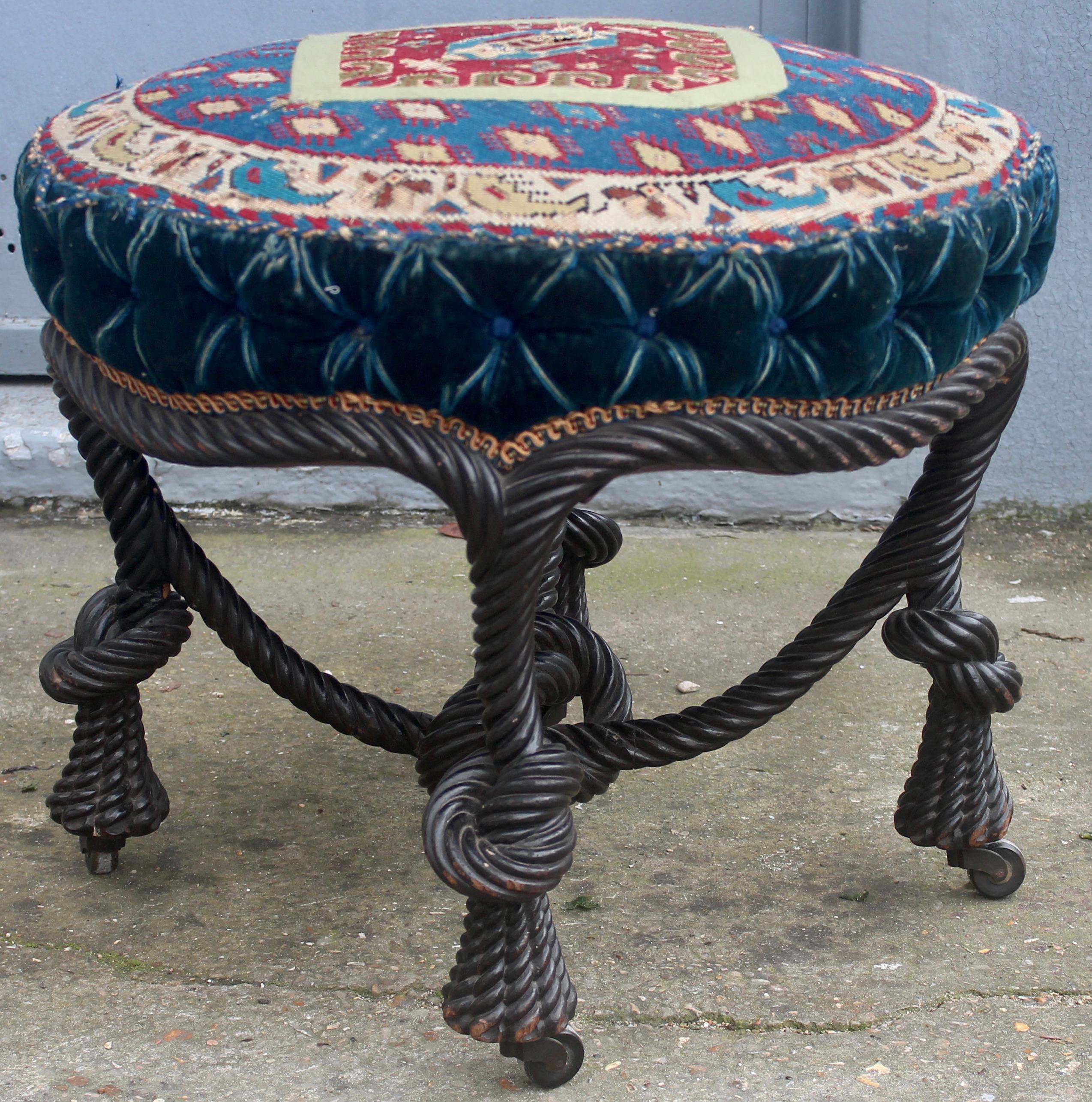 A French Napoléon III carved blackened wood rope rare and large stool
Rope stool in blackened wood, decorated with trimmings twisted feet in the shape of a pompon finished by casters, resting on wheels.
Upholstery trim with petit point “Paisley”