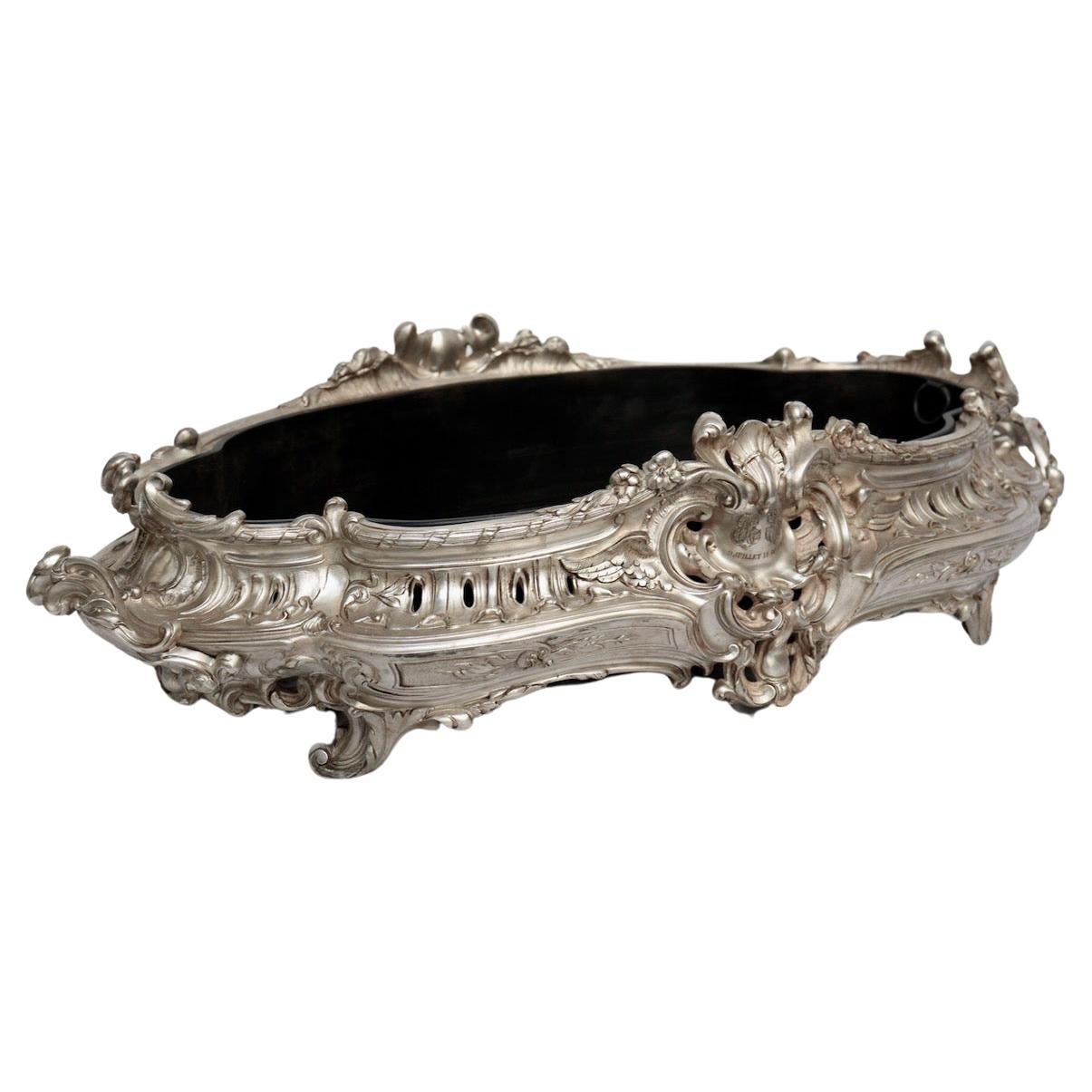 A French Napoléon III oval silvered bronze Jardiniere centerpiece
With two handles and resting on four feet
Richly decorated with rocailles, garlands and acanthus leaves
Engraved in the Rococo cartouche with the two monograms of a wife and his