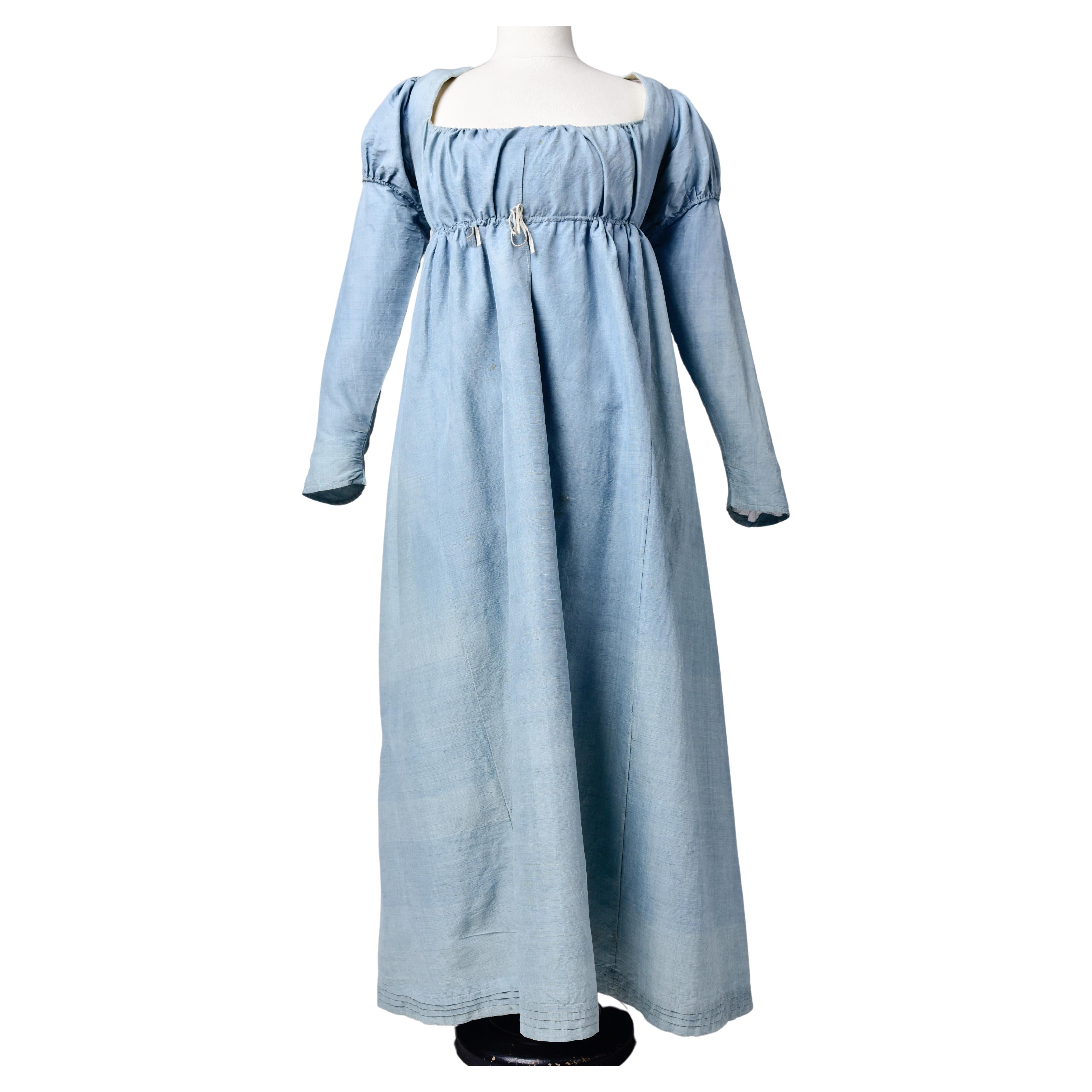 Circa 1800-1805
France

Rare pastel blue silk day dress for the petite bourgeoisie dating from the French Consulat or the beginning of the Premier Empire. Background in gros de Naples silk with wild silk effect and variations in colour of the indigo