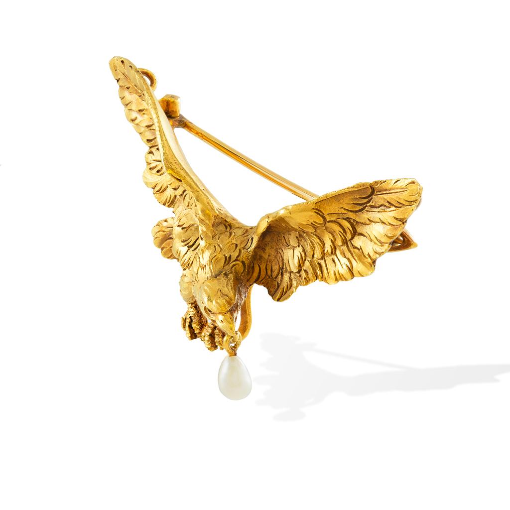 A French nineteenth century carved gold eagle brooch, the eagle magnificently carved in yellow gold with outstretched wings carrying an pearl in its beak with rat-tail and pin fitting to reverse, stamped with the French eagle head export mark, circa