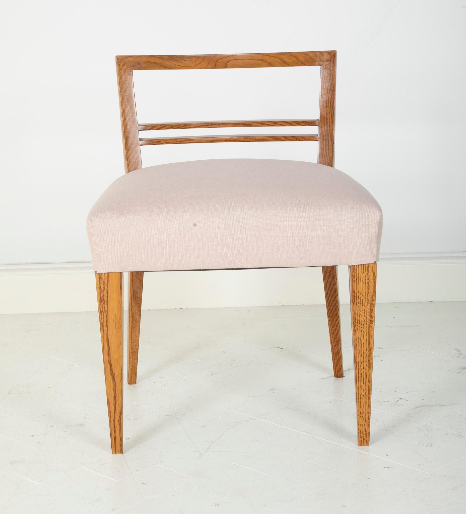 A midcentury French table chair in oak. Sold individually, pair available.