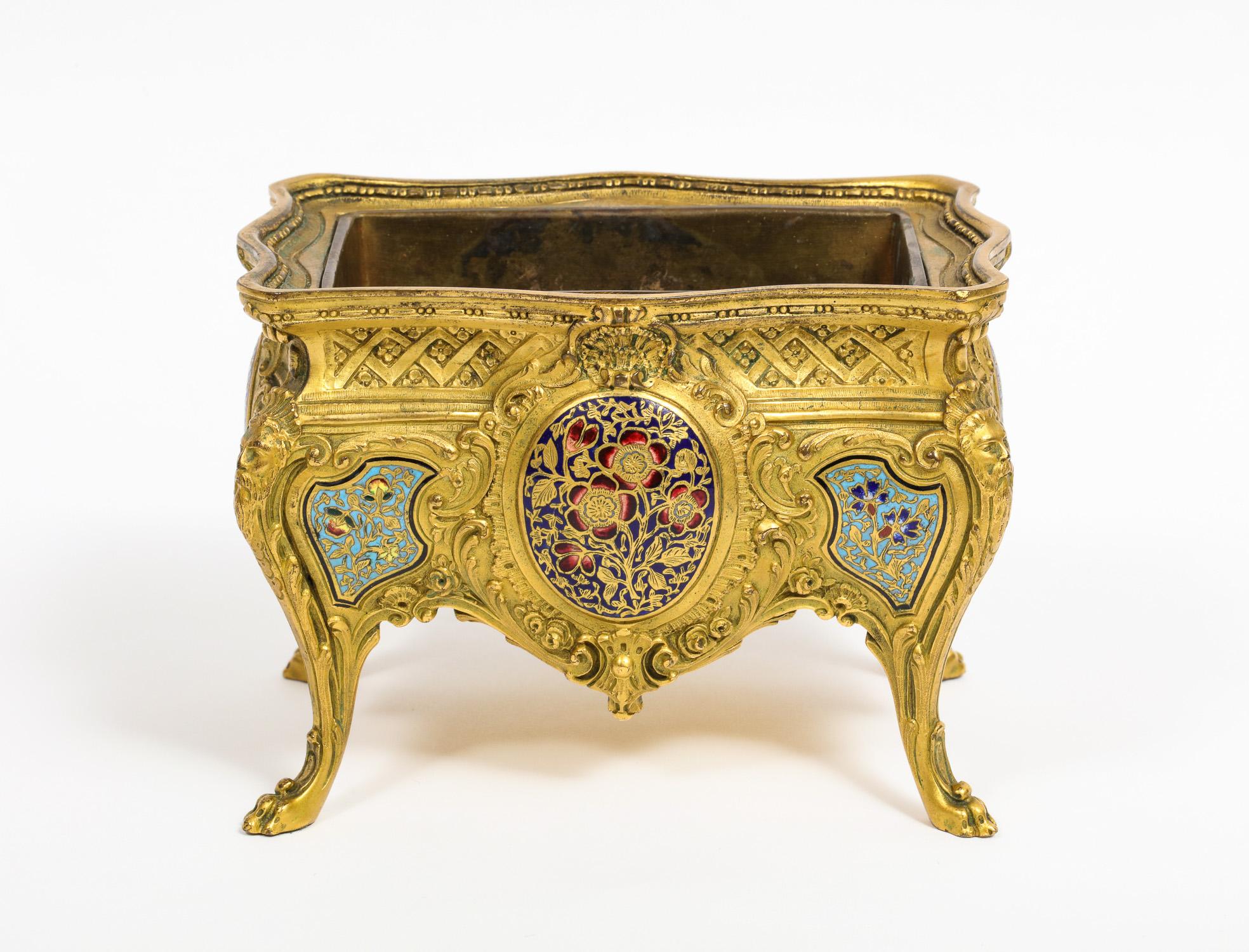 A French ormolu, bronze and Champlevé cloisonné enamel jardiniere centerpiece, in the form of a commode, circa 1880.

Beautiful quality ormolu and enamel, with original liner.

Can be used as a planter, cachepot, centerpiece, or