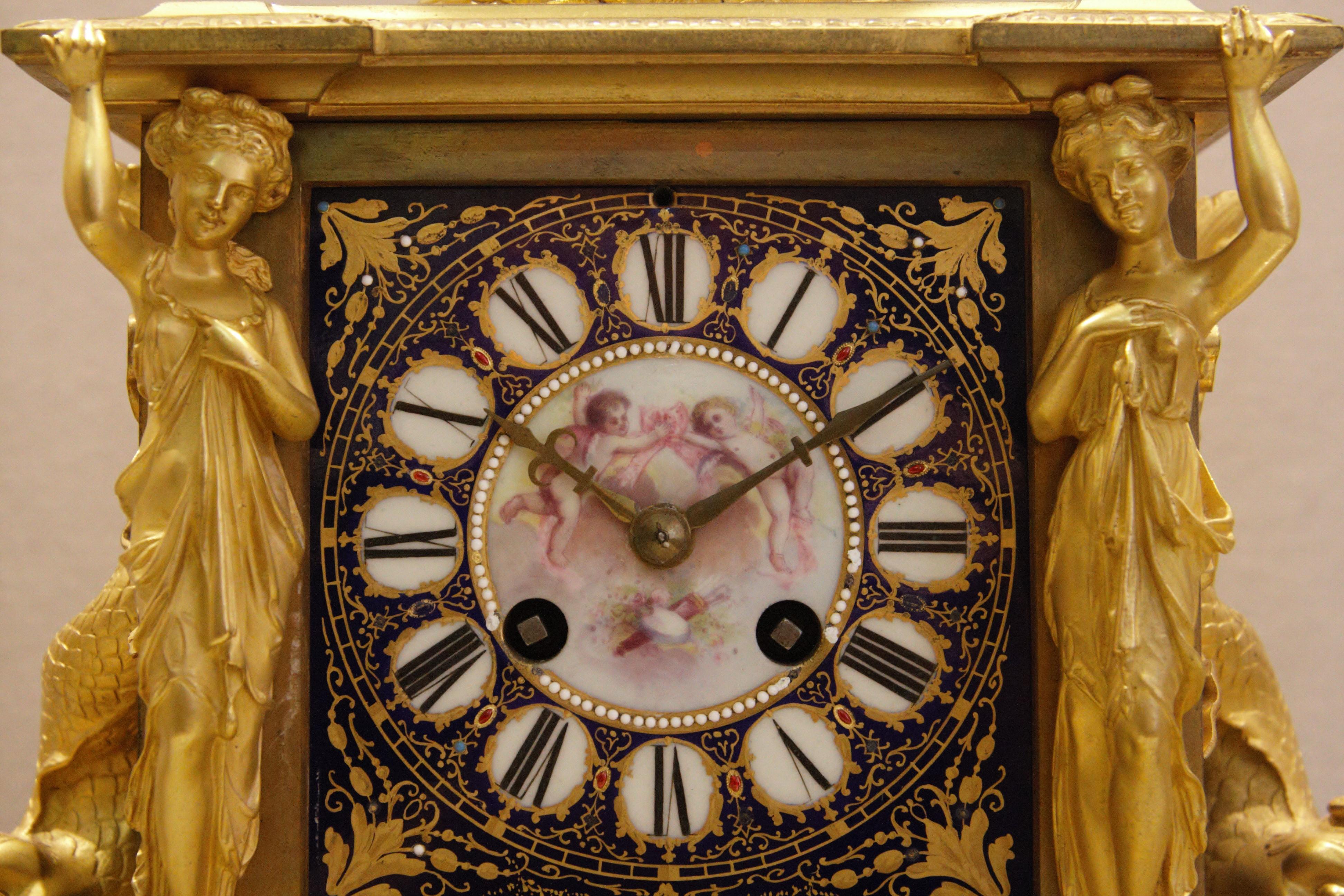 A French ormolu-mounted jeweled Sèvres Porcelain clock set, circa 1880. The ormolu is of very high quality and the porcelain is very finely hand painted with jewels.