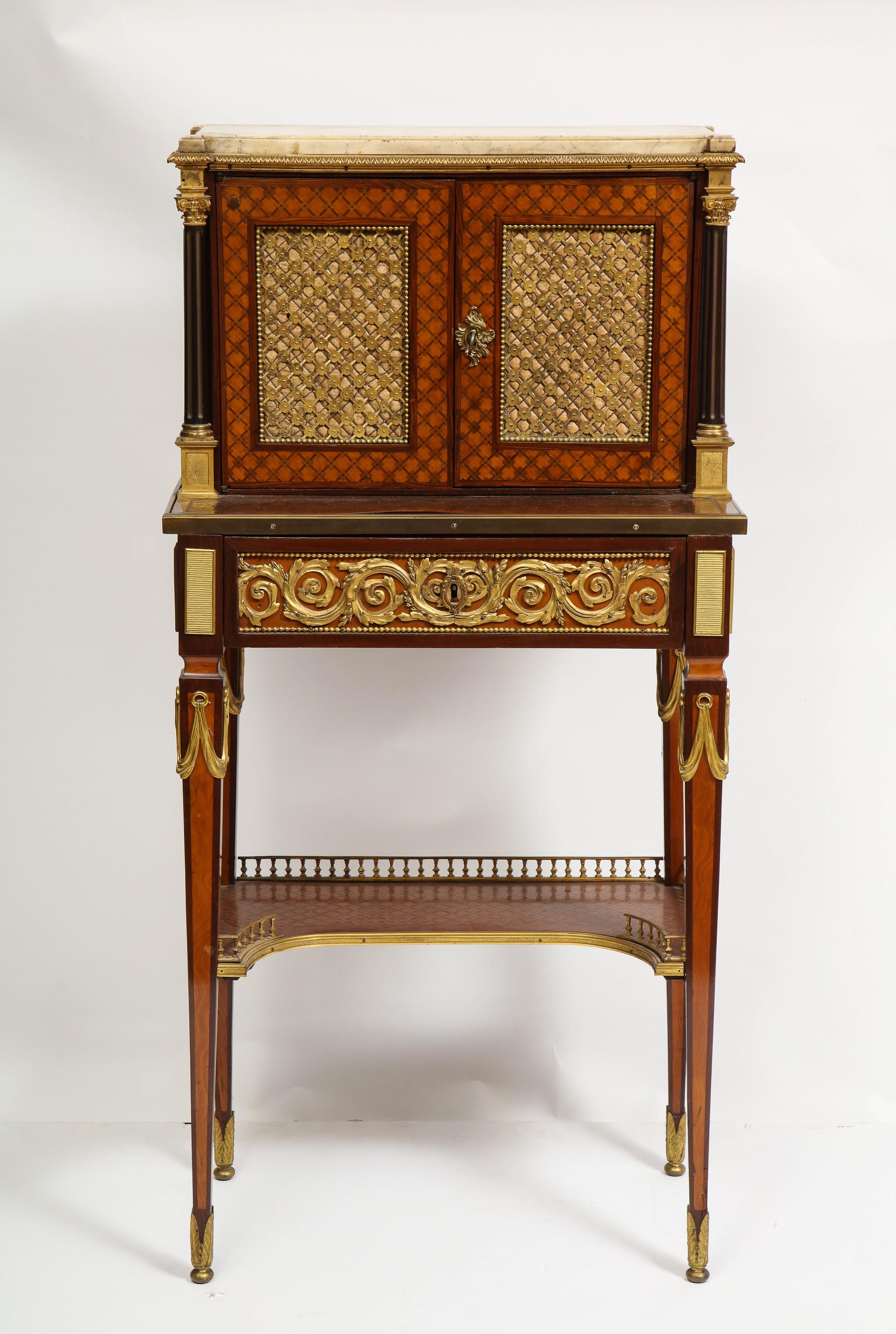 A French Ormolu Mounted mahogany Bonheur Du Jour, attributed to Henry Dasson, circa 1870.

Very fine quality French ormolu mounts throughout, with marble top, two doors revealing two shelves, a sliding drawer and a galley.

Although unsigned,